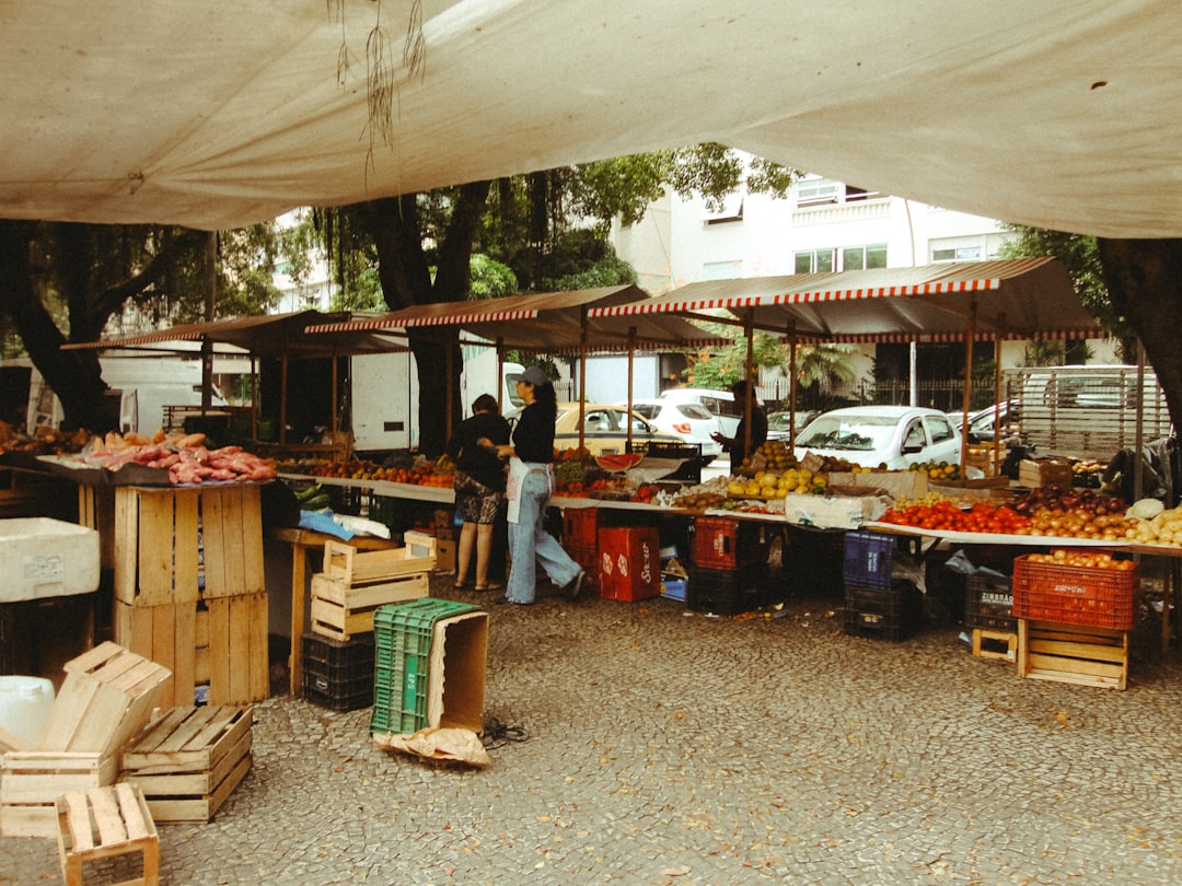 Outdoor market stalls with fresh produce and crates.